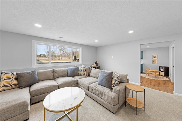 living area with recessed lighting, a textured ceiling, and carpet flooring
