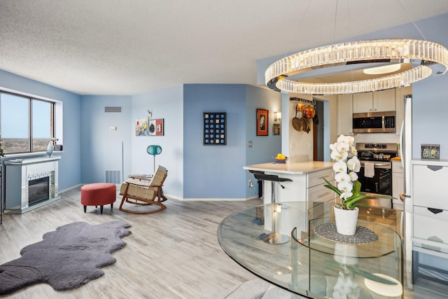 dining area featuring light wood-style floors, baseboards, and visible vents