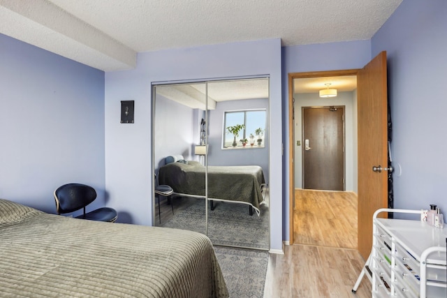 78 10th St E Unit 3009, Saint Paul, MN 55101 - bedroom with a textured ceiling, a closet, and wood finished floors
