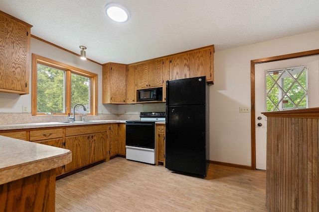 25431 Larch St NW, Isanti, MN 55040 - kitchen featuring black appliances, light wood-type flooring, brown cabinetry, and a textured ceiling