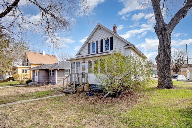 1040 26th Ave SE, Minneapolis, MN 55414 - bungalow-style home featuring a front yard and a chimney
