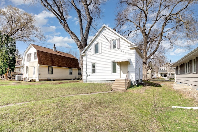 1040 26th Ave SE, Minneapolis, MN 55414 - rear view of property with central AC, entry steps, and a lawn