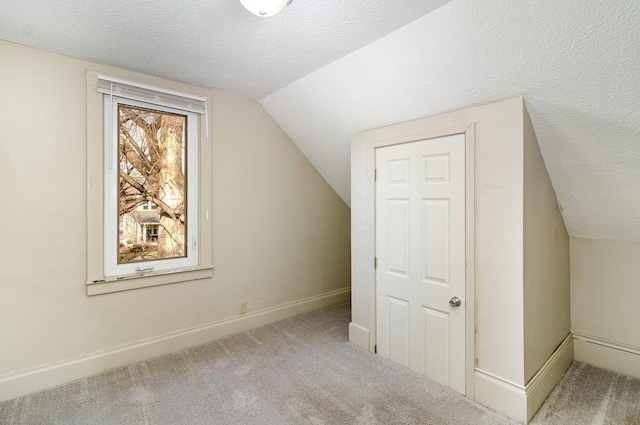 1040 26th Ave SE, Minneapolis, MN 55414 - additional living space with a textured ceiling, carpet flooring, and vaulted ceiling