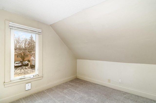 1040 26th Ave SE, Minneapolis, MN 55414 - additional living space featuring baseboards, carpet, and lofted ceiling