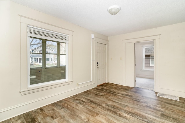 1040 26th Ave SE, Minneapolis, MN 55414 - empty room with visible vents, wood finished floors, and baseboards