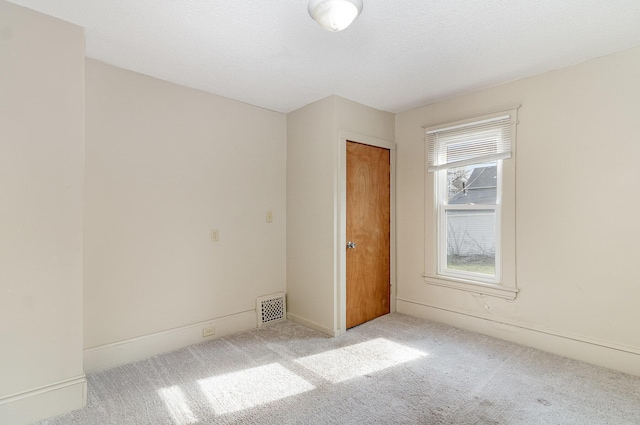 1040 26th Ave SE, Minneapolis, MN 55414 - carpeted spare room featuring visible vents and baseboards