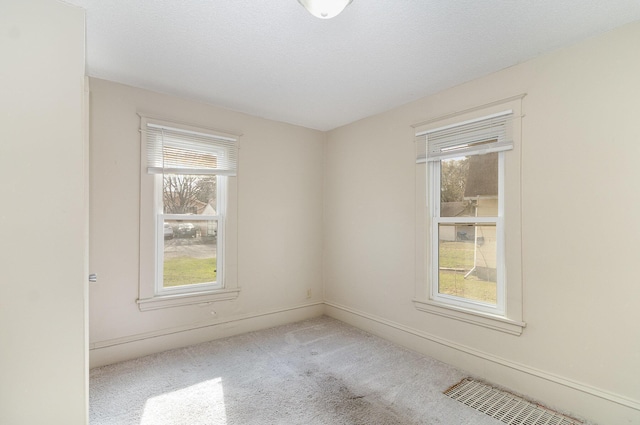 1040 26th Ave SE, Minneapolis, MN 55414 - spare room with visible vents, carpet flooring, and baseboards
