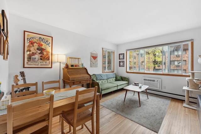 2112 Garfield Ave Unit 6, Minneapolis, MN 55405 - living area with a baseboard heating unit, a wall unit AC, and light wood-style flooring
