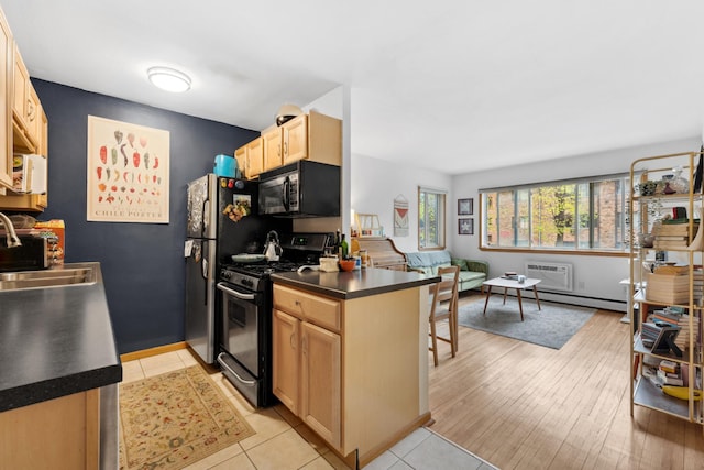 2112 Garfield Ave Unit 6, Minneapolis, MN 55405 - kitchen featuring black microwave, dark countertops, gas stove, a sink, and light brown cabinets