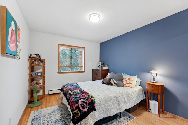 2112 Garfield Ave Unit 6, Minneapolis, MN 55405 - bedroom featuring light wood-style floors, baseboards, and a baseboard heating unit