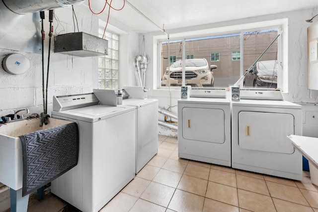 2112 Garfield Ave Unit 6, Minneapolis, MN 55405 - community laundry room featuring washer and dryer, light tile patterned floors, and a sink