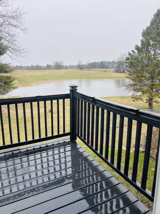 wooden terrace featuring a water view
