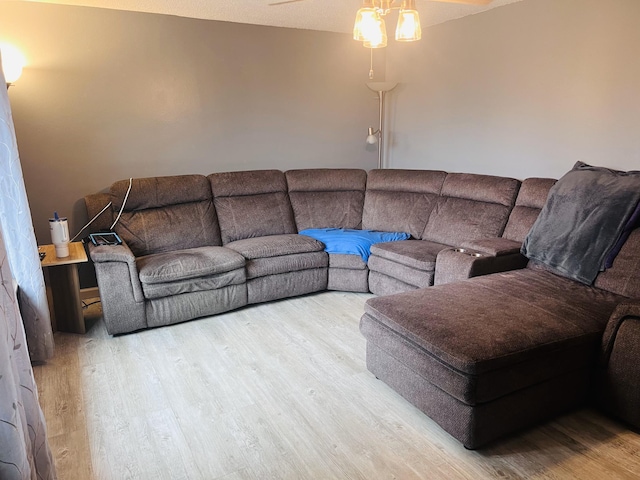 living room with wood finished floors and a ceiling fan