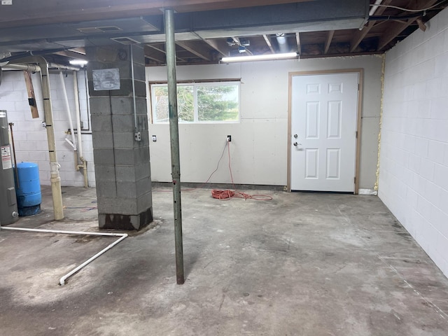 below grade area with concrete block wall and electric water heater