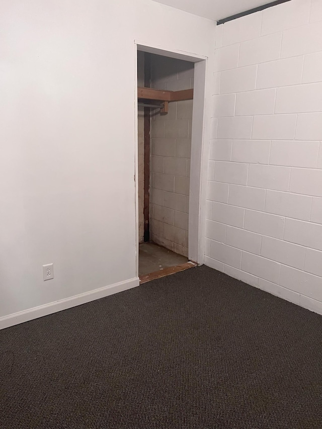 carpeted empty room featuring baseboards