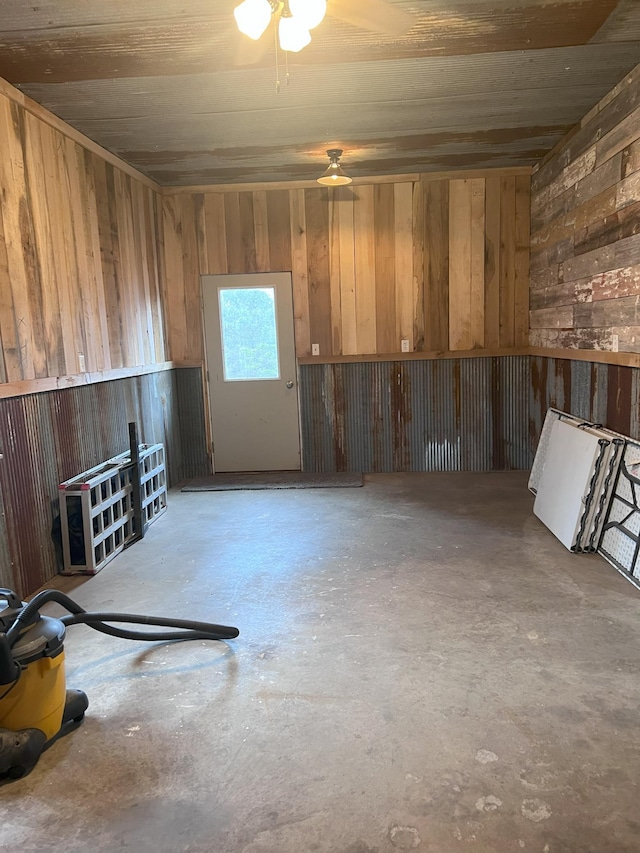 interior space with wood walls and concrete flooring