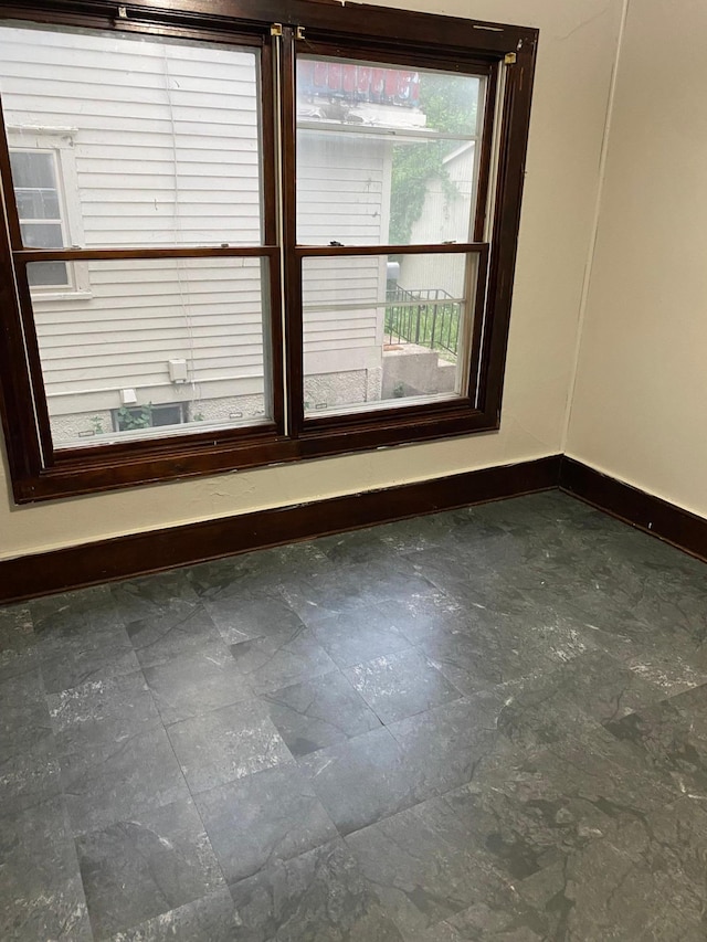 spare room with baseboards