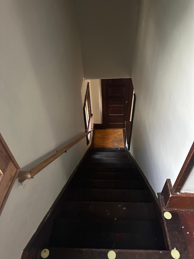 staircase with wood finished floors