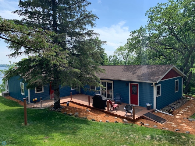 23062 Gosslee Ln, Dunn Twp, MN 56501 - view of front of house with a wooden deck, a front lawn, and roof with shingles
