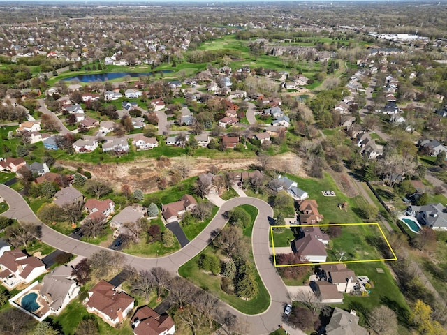 birds eye view of property featuring a water view and a residential view