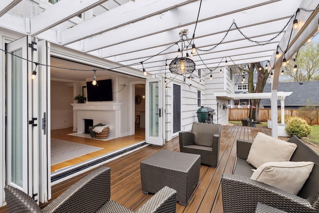 wooden terrace featuring fence, a pergola, area for grilling, and outdoor lounge area