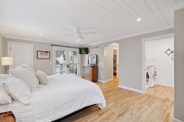 bedroom with visible vents, crown molding, access to outside, washing machine and clothes dryer, and arched walkways