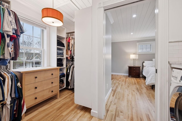 spacious closet with washer / dryer and wood finished floors