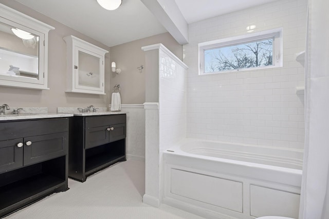 bathroom with vanity, wainscoting, and bathing tub / shower combination
