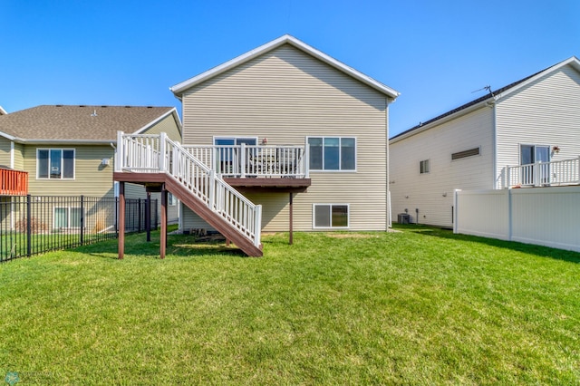 rear view of property with a wooden deck, a fenced backyard, stairs, central AC unit, and a yard