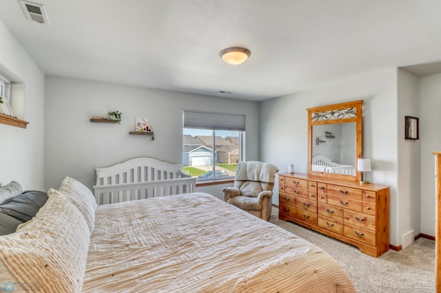 carpeted bedroom with baseboards and visible vents