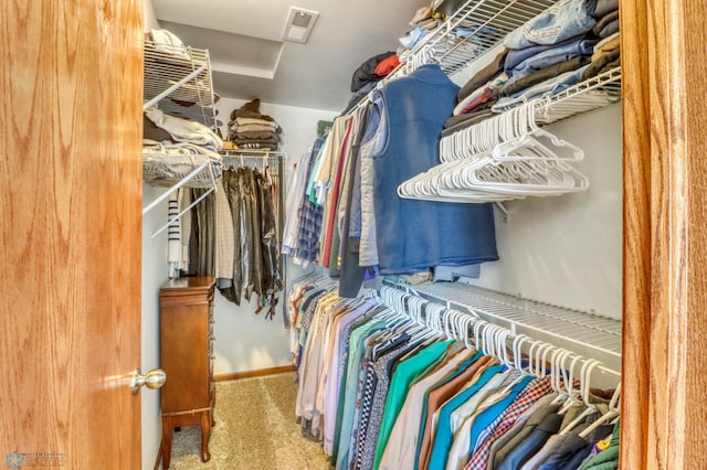 walk in closet featuring visible vents and carpet