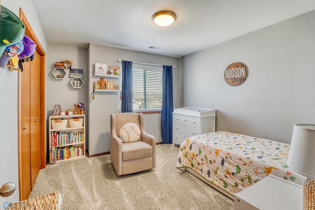 carpeted bedroom featuring baseboards and visible vents