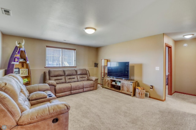 living room featuring carpet flooring, baseboards, and visible vents