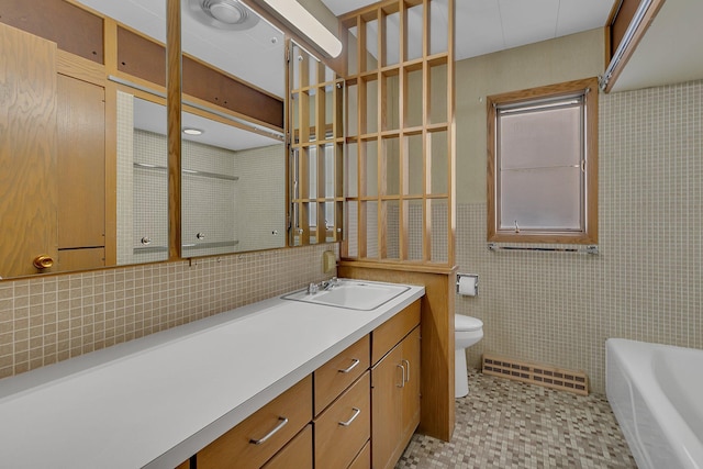 420 6th Ave N, Cold Spring, MN 56320 - full bath with a bathing tub, baseboard heating, toilet, tile walls, and vanity