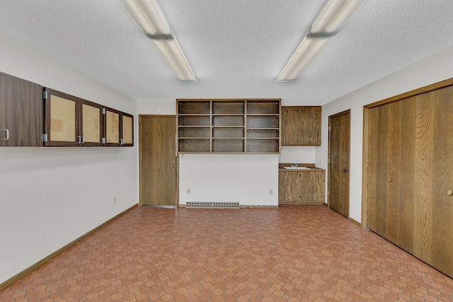 420 6th Ave N, Cold Spring, MN 56320 - unfurnished living room featuring a textured ceiling and a sink