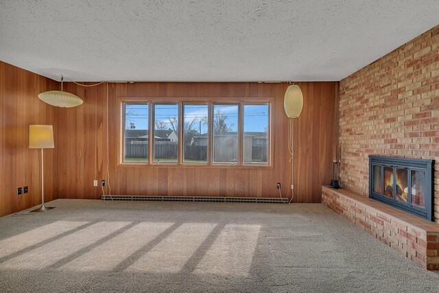 420 6th Ave N, Cold Spring, MN 56320 - unfurnished living room with wooden walls, a textured ceiling, a fireplace, and carpet floors