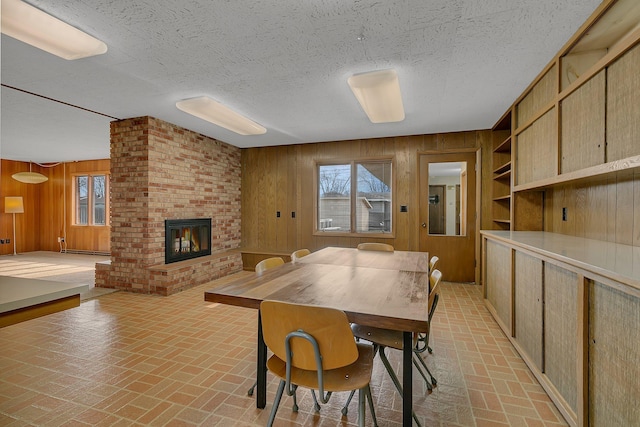 420 6th Ave N, Cold Spring, MN 56320 - dining room with wooden walls, a brick fireplace, brick floor, and a wealth of natural light