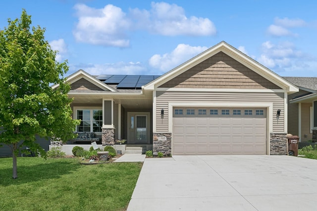 1703 11th St NE, Buffalo, MN 55313 - craftsman house featuring a garage, a front lawn, concrete driveway, solar panels, and stone siding