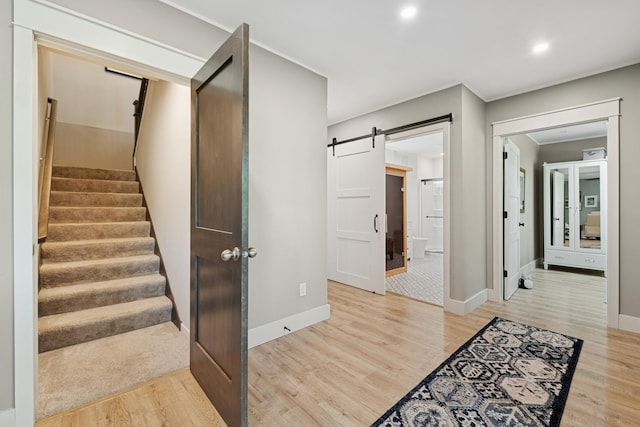 1703 11th St NE, Buffalo, MN 55313 - stairway with wood finished floors, a barn door, baseboards, and recessed lighting