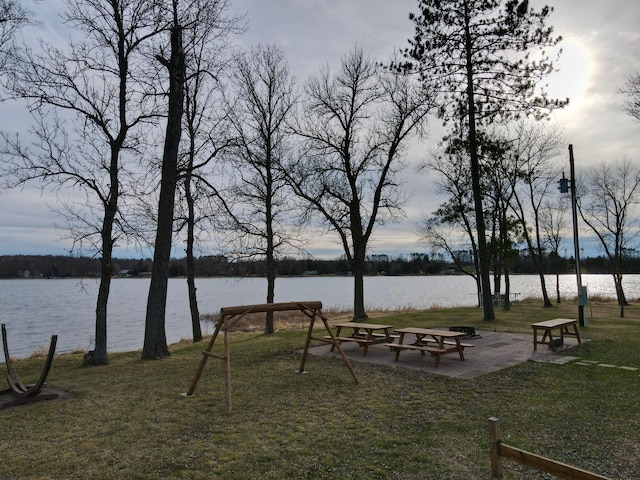 surrounding community featuring a yard and a water view