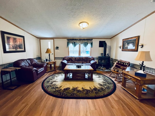 living room with a wood stove, wood finished floors, lofted ceiling, and crown molding