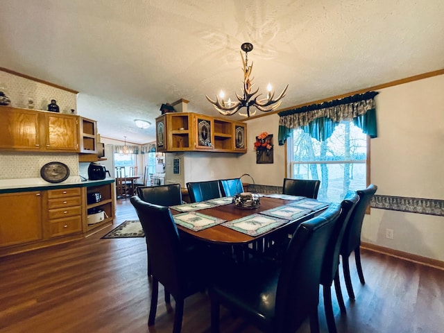 dining area with dark wood-style flooring, baseboards, a notable chandelier, and a textured ceiling