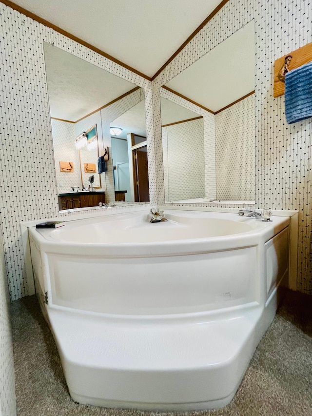 bathroom featuring wallpapered walls and a bath