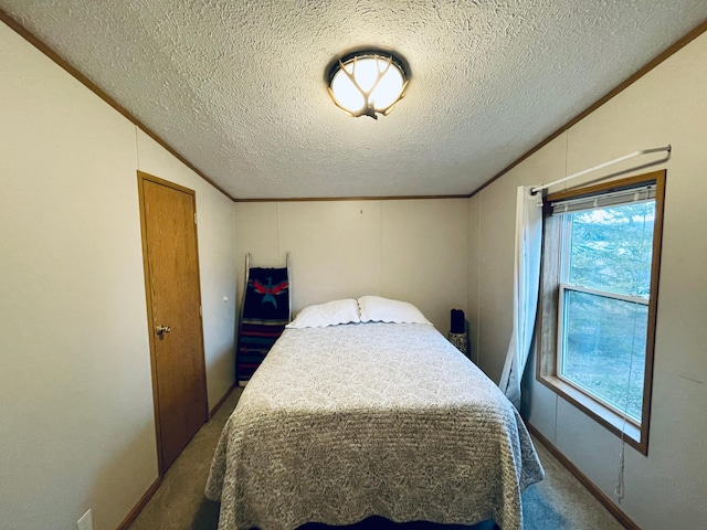 bedroom with a textured ceiling, carpet flooring, and vaulted ceiling