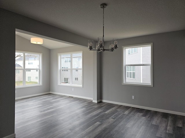 17121 61st St NE, Otsego, MN 55330 - unfurnished dining area featuring a chandelier, dark wood-style floors, and a healthy amount of sunlight