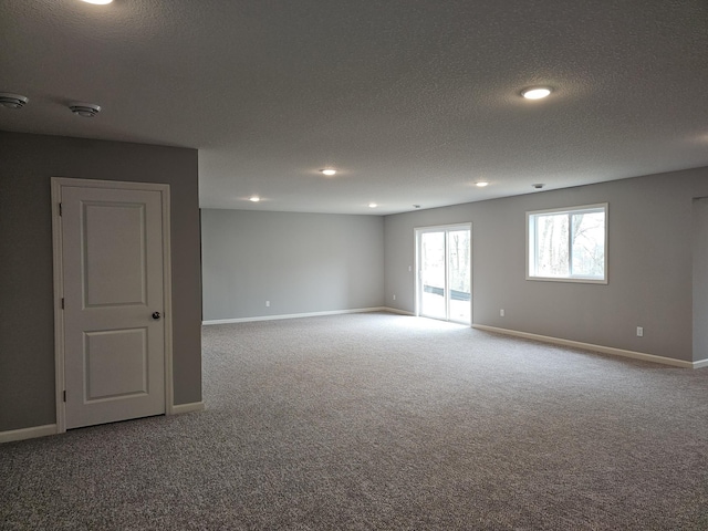 17121 61st St NE, Otsego, MN 55330 - empty room featuring carpet floors, baseboards, and a textured ceiling