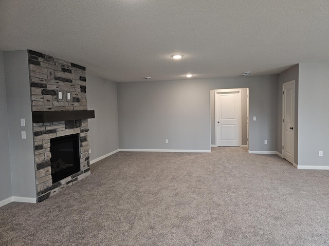 17121 61st St NE, Otsego, MN 55330 - unfurnished living room featuring baseboards, a fireplace, carpet flooring, and a textured ceiling