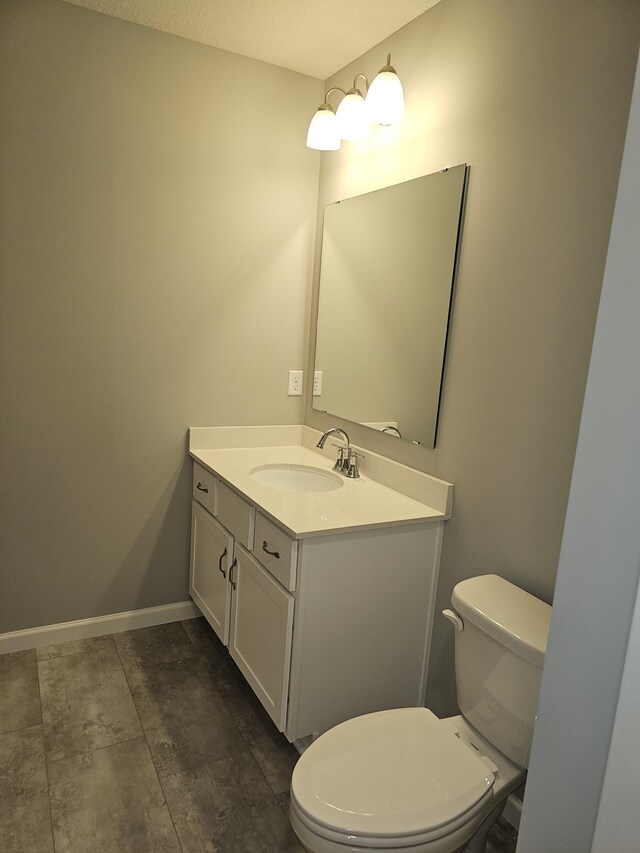 17121 61st St NE, Otsego, MN 55330 - bathroom featuring toilet, baseboards, and vanity