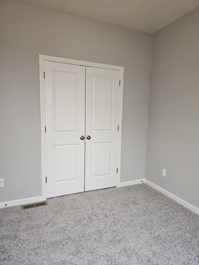 17121 61st St NE, Otsego, MN 55330 - unfurnished bedroom featuring carpet floors, baseboards, visible vents, and a closet