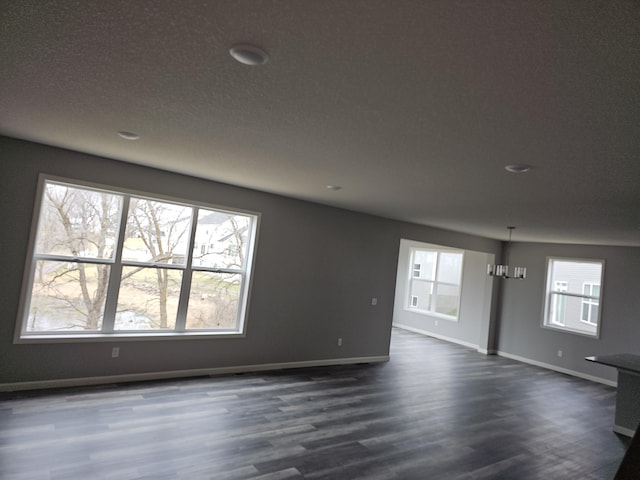 17121 61st St NE, Otsego, MN 55330 - unfurnished living room with baseboards, a textured ceiling, dark wood-style flooring, and recessed lighting